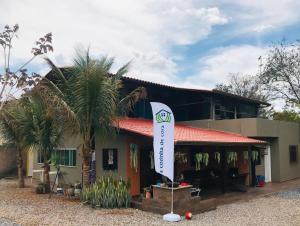 a house with a flag in front of it at Hostel A Cozinha de Cora in Brasilia