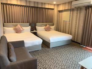 Postel nebo postele na pokoji v ubytování Chi Shing Hai Hotel