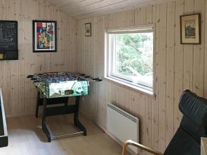 a room with a table in the corner of a room at 12 person holiday home in R dby in Kramnitse