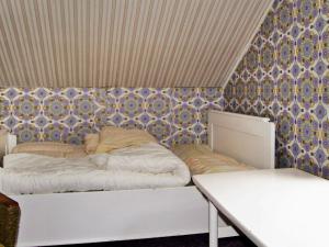 a bedroom with a bed and a table and a wall at Five-Bedroom Holiday home in Masfjordnes in Masfjorden