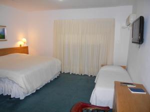מיטה או מיטות בחדר ב-Tanger Hotel