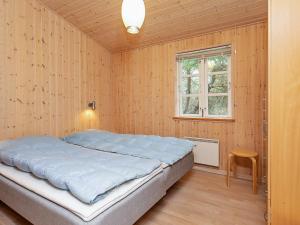 a bedroom with a large bed and a window at 6 person holiday home in Rødby-By Traum in Rødby