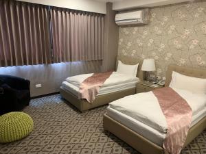 Postel nebo postele na pokoji v ubytování Chi Shing Hai Hotel