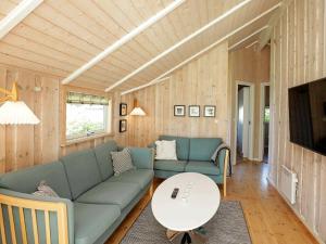 a living room with a couch and a table at 5 person holiday home in Esbjerg V in Esbjerg