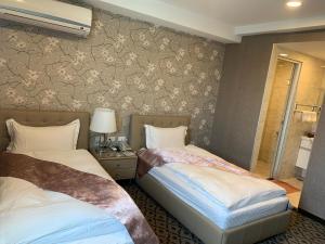 Postel nebo postele na pokoji v ubytování Chi Shing Hai Hotel