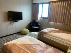 Postel nebo postele na pokoji v ubytování Chi Shing Hai Hotel