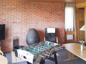 a ping pong table in front of a brick wall at 8 person holiday home in Harbo re in Vrist
