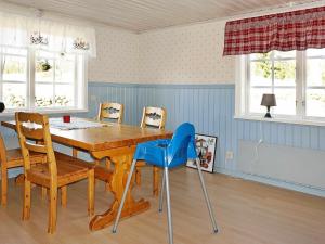 a dining room with a wooden table and chairs at 6 person holiday home in STOCKARYD in Stockaryd