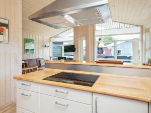 a kitchen with a stove and a counter top at 6 person holiday home in Tranek r in Tranekær