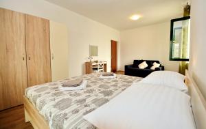 a bedroom with a large bed and a couch at Villa Allegro in Sukošan +64 photos