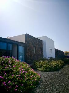 a building with some flowers in front of it at Villa Shepherd Lajares - LUXURY VILLA FUERTEVENTURA in Lajares