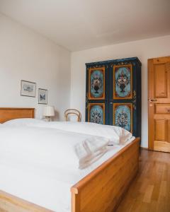 a bedroom with a large bed and a blue cabinet at Apartments Pfeffermühle in Bad Kleinkirchheim