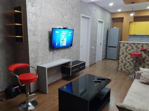 a living room with a tv on a wall at Your home in Kutaisi