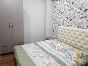 a bedroom with a bed with a floral wallpaper at Your home in Kutaisi