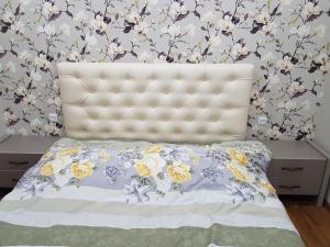 a bedroom with a bed with a floral wallpaper at Your home in Kutaisi