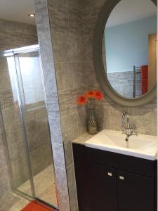 a bathroom with a sink and a mirror at SeaSure in Bexhill