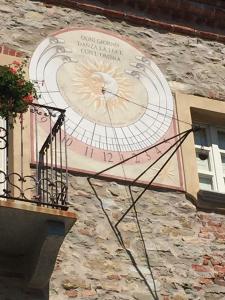 un grande orologio sul lato di un edificio di Dimora Storico Romantica Il Sole E La Luna a Cerretto Langhe