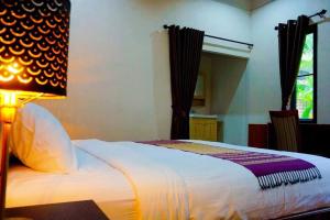 Postel nebo postele na pokoji v ubytování Punyin Hotel Inthanon -ปั้นหยิ่น โฮเทล