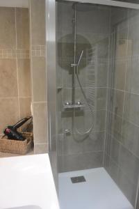 a shower with a glass door in a bathroom at St CYPRIEN C20 in San Ciprianu