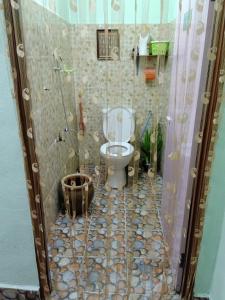 a bathroom with a toilet in a shower at Homestay Damai Sri Kota in Kepala Batas