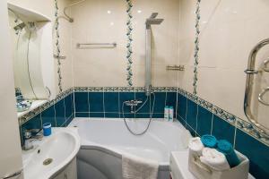 a bathroom with a tub and a sink at PaulMarie Apartments on Zaslonova Street 70 in Soligorsk