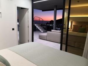 A bed or beds in a room at The One Luxury Apartments