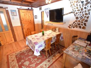 a room with a table and a tv on the wall at Holiday home in Erzgebirge Mountains with terrace in Mezihoří