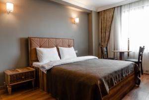 a hotel room with a large bed and a window at madame roza in Istanbul