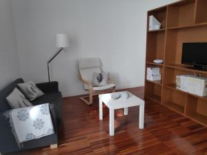 uma sala de estar com um sofá e uma mesa em Casa do Arco, Santarém em Santarém