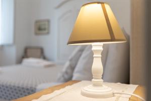 a white lamp sitting on top of a table at Mercatale Apartment in Prato