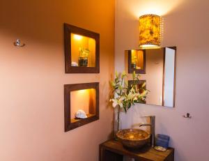 a bathroom with a sink and mirrors on the wall at Hotel Casa Mixteca in Zipolite
