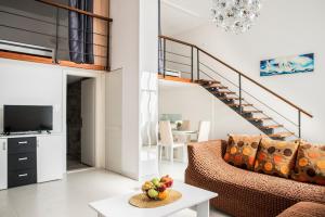 a living room with a couch and a staircase at Apartment Alja, Sara i Nevio jacuzzi in Dugi Rat