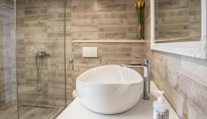 a bathroom with a white sink and a shower at Apartment Alja, Sara i Nevio jacuzzi in Dugi Rat +109 photos