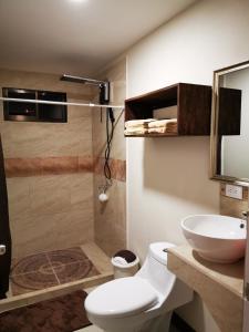 a bathroom with a shower and a toilet and a sink at CASA GERANIOS STUDIO #3 in Monteverde Costa Rica