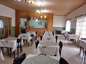 a dining room with white tables and chairs at Hotel Alonso in Río Gallegos +16 photos