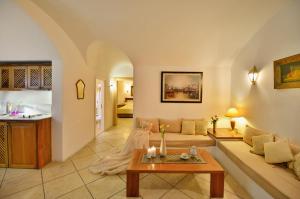 a living room with a couch and a table at Tamarix Del Mar Suites in Kamari
