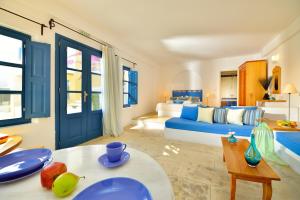 a bedroom with a bed and a table with fruit on it at Tamarix Del Mar Suites in Kamari