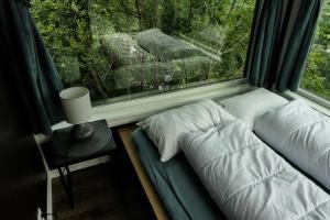 a bed sitting next to a window in a room at Hardanger Panorama Lodge in Ulvik