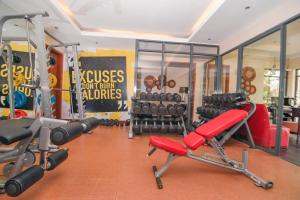 a gym with dumbbells and equipment in a room at Falcon heights Hotel in Nanyuki