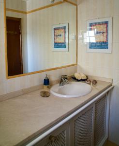 a bathroom counter with a sink and a mirror at Casa Mar e Serra in Cascais