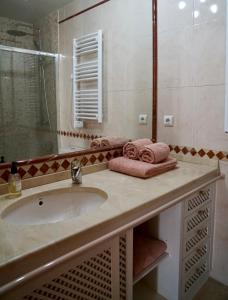 a bathroom with a sink and a shower at Casa Mar e Serra in Cascais