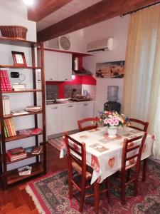 a kitchen with a table and chairs in a room at Domus Accomodations in Palermo