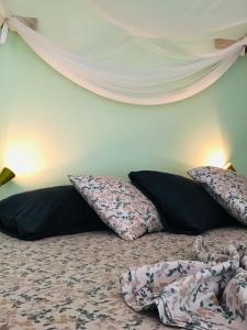 a bedroom with a bed with pillows on it at Alibaba‘s Seabreeze in Castara