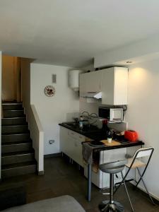 a small kitchen with a counter and a microwave at Casa Cachita 2-Confortable Estudio a pie de playa in Estepona