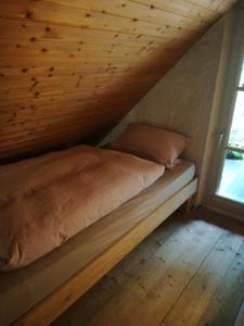 Cama en habitación con techo de madera en Ferienhaus in Rumke en Bippen