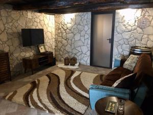 a living room with a couch and a tv at Casa Lisetta in Villa D'agri