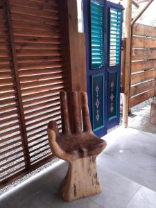 a statue of a wooden hand sitting in front of a door at The BlueBamboo in Le Moule