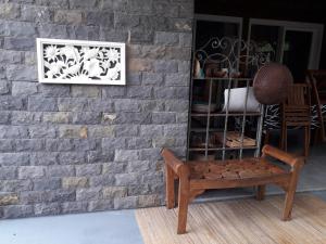 a chair sitting in front of a brick wall at The BlueBamboo in Le Moule