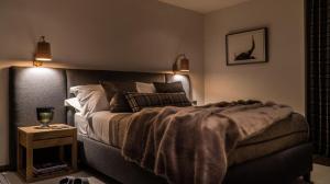 um quarto com uma cama e uma mesa com um copo de vinho em Ski Heaven 7 em Veysonnaz