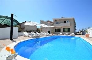 a swimming pool in front of a villa at Villa Allegro in Sukošan